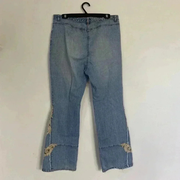 Light wash flare jeans with lace embellishments. - Picture 2 of 5